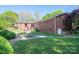 Brick home featuring a beautiful backyard with a well-maintained lawn and a cozy patio area at 821 Mark St, Belmont, NC 28012