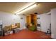 Spacious basement area with red painted floor and ample storage potential at 821 Mark St, Belmont, NC 28012