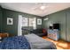 Inviting bedroom with green paneling, hardwood floors, and a comfortable futon at 821 Mark St, Belmont, NC 28012