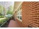 Close-up view of the brick exterior with white-framed windows and a charming brick walkway at 821 Mark St, Belmont, NC 28012