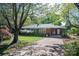 Beautiful brick home with a green door, mature trees, and a lovely front yard at 821 Mark St, Belmont, NC 28012