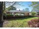 Inviting brick ranch-style home with lush landscaping and a green door at 821 Mark St, Belmont, NC 28012