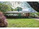 Charming brick home with a well-manicured lawn, vibrant azaleas, and a welcoming green front door at 821 Mark St, Belmont, NC 28012