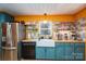 Stylish kitchen featuring teal cabinets, butcher block countertops, and colorful tile backsplash at 821 Mark St, Belmont, NC 28012