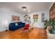Bright living room with hardwood floors, plants, and natural light from large window at 821 Mark St, Belmont, NC 28012