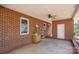 Enclosed brick patio offering a versatile outdoor space with a ceiling fan and a window at 821 Mark St, Belmont, NC 28012