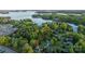 Aerial view of a home on a lake featuring a private pool and lush green trees at 8271 Camelia Ln, Denver, NC 28037