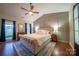 Serene bedroom retreat with paneled accent wall, fan, hardwood floors, and bright windows at 8271 Camelia Ln, Denver, NC 28037