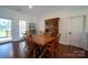 Light-filled dining room with hardwood floors, wooden table/chairs, and a wooden hutch at 8271 Camelia Ln, Denver, NC 28037