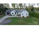 Charming home with fresh exterior paint, manicured landscaping, and a private driveway at 8271 Camelia Ln, Denver, NC 28037