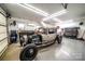 Spacious garage featuring a vintage car, tool storage, and ample workspace at 8271 Camelia Ln, Denver, NC 28037
