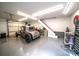Spacious garage featuring a classic car, workspace area, and stairs to the second floor at 8271 Camelia Ln, Denver, NC 28037