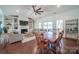Open concept living/dining boasts natural light, fireplace, custom built-ins and a patio view at 8271 Camelia Ln, Denver, NC 28037