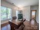 Bright home office with a large window, crown molding, and built-in desk with nearby half bathroom at 8271 Camelia Ln, Denver, NC 28037