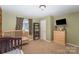 Green bedroom with wood bookshelf and dresser, and a bed at 833 Old Charlotte Sw Rd, Concord, NC 28027