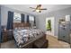 Gray bedroom with mounted ceiling fan, wood-look bed frame, and personal safe at 833 Old Charlotte Sw Rd, Concord, NC 28027