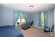 Blue bedroom with light blue curtains and carpet at 833 Old Charlotte Sw Rd, Concord, NC 28027