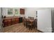 Eat-in kitchen dining area features wood-look flooring and seating for six near the window at 833 Old Charlotte Sw Rd, Concord, NC 28027