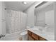 Well-lit bathroom with a bathtub, shower, vanity, and polka-dot shower curtain at 8453 Mossy Cup Trl, Harrisburg, NC 28075