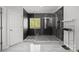 Modern bathroom showcasing walk-in shower, mosaic tile and sleek fixtures at 8453 Mossy Cup Trl, Harrisburg, NC 28075