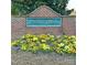 An ornate, brick sign welcomes residents to Magnolia Springs with colorful flowers planted below at 8453 Mossy Cup Trl, Harrisburg, NC 28075