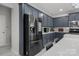 Modern kitchen boasts stainless steel appliances, gray cabinets, and stylish backsplash at 8453 Mossy Cup Trl, Harrisburg, NC 28075