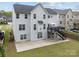 Spacious backyard featuring a patio and a deck with an umbrella, perfect for outdoor entertaining at 8453 Mossy Cup Trl, Harrisburg, NC 28075