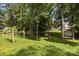 Spacious, wooded backyard with a fire pit area and plenty of room for outdoor activities at 8835 Glencroft Rd, Mint Hill, NC 28227