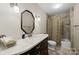 Bathroom featuring a modern vanity with sink, and a shower-tub combo offering a clean and functional design at 8835 Glencroft Rd, Mint Hill, NC 28227
