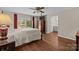 Bedroom featuring hardwood floors, natural light, and a connecting bathroom creating a comfortable private retreat at 8835 Glencroft Rd, Mint Hill, NC 28227