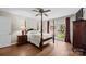 Bedroom with a four-poster bed, hardwood floors, and bright windows offers a peaceful and relaxing atmosphere at 8835 Glencroft Rd, Mint Hill, NC 28227
