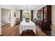 Elegant dining room with hardwood floors, large window, and traditional furnishings for formal dining at 8835 Glencroft Rd, Mint Hill, NC 28227