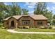 Charming home featuring a stone facade, meticulously landscaped yard, and classic architectural details at 8835 Glencroft Rd, Mint Hill, NC 28227