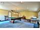 Bright game room with a billiard table, pendant lighting, and comfortable seating area at 8835 Glencroft Rd, Mint Hill, NC 28227