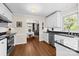 Modern kitchen featuring white cabinets, granite countertops, stainless steel appliances, and hardwood floors at 8835 Glencroft Rd, Mint Hill, NC 28227