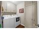Functional laundry room with washer, dryer, and ample storage cabinets for convenience at 8835 Glencroft Rd, Mint Hill, NC 28227
