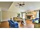 Bright living room featuring hardwood floors, a brick fireplace, and comfortable seating offers a welcoming space at 8835 Glencroft Rd, Mint Hill, NC 28227