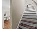 A charming staircase with wooden steps and white risers, leading to the upper level of the home at 8835 Glencroft Rd, Mint Hill, NC 28227