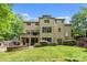 Beautiful backyard featuring a stone fireplace, patio, and lush green lawn, perfect for entertaining at 914 Elizabeth Ln, Matthews, NC 28105