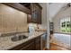 Elegant bar area with custom cabinets, granite countertops, wine rack, and beverage refrigerator at 914 Elizabeth Ln, Matthews, NC 28105