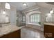 Luxurious bathroom featuring dual sinks, a soaking tub, a glass-enclosed shower, and elegant tile work at 914 Elizabeth Ln, Matthews, NC 28105