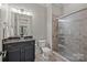 Bathroom featuring a granite vanity, toilet, and tiled shower at 914 Elizabeth Ln, Matthews, NC 28105