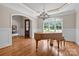 Elegant dining room with a grand piano, chandelier, and ample natural light at 914 Elizabeth Ln, Matthews, NC 28105