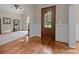 Elegant entryway with hardwood floors, white wainscoting, and a glimpse into a bright, inviting room at 914 Elizabeth Ln, Matthews, NC 28105