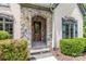 Close-up of the front entrance featuring a stone archway and wooden door at 914 Elizabeth Ln, Matthews, NC 28105
