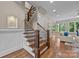 Entryway with beautiful hardwood floors, a staircase with wood and iron railings, and natural lighting at 914 Elizabeth Ln, Matthews, NC 28105