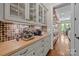 Butler's pantry area with custom cabinets, granite countertops, and coffee bar at 914 Elizabeth Ln, Matthews, NC 28105