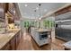 Bright kitchen with a center island, stainless steel appliances, custom cabinets, and breakfast bar at 914 Elizabeth Ln, Matthews, NC 28105