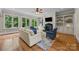 Open concept living room has a fireplace, hardwood floors, and built-in cabinets at 914 Elizabeth Ln, Matthews, NC 28105