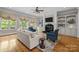 Bright living room features a fireplace, custom built-ins and large windows at 914 Elizabeth Ln, Matthews, NC 28105